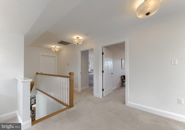 hallway with light colored carpet