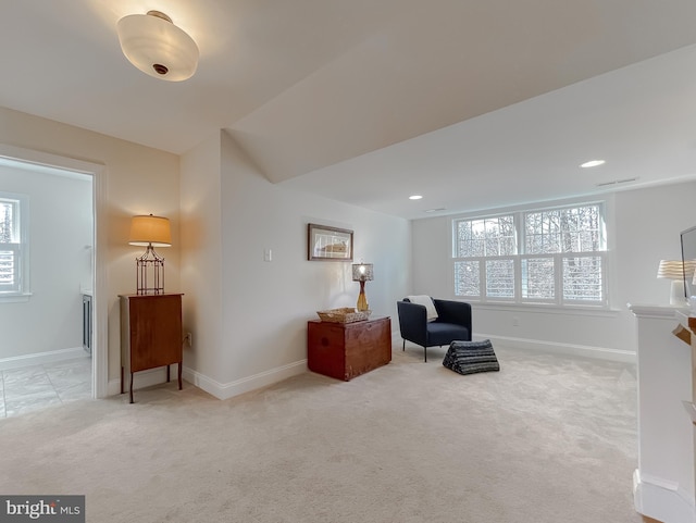 living area featuring light carpet