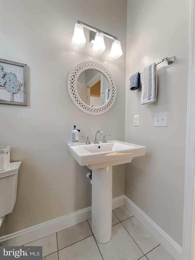 bathroom with tile patterned flooring, toilet, and sink