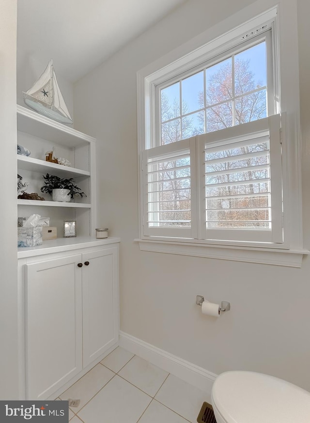 bathroom with tile patterned flooring and toilet