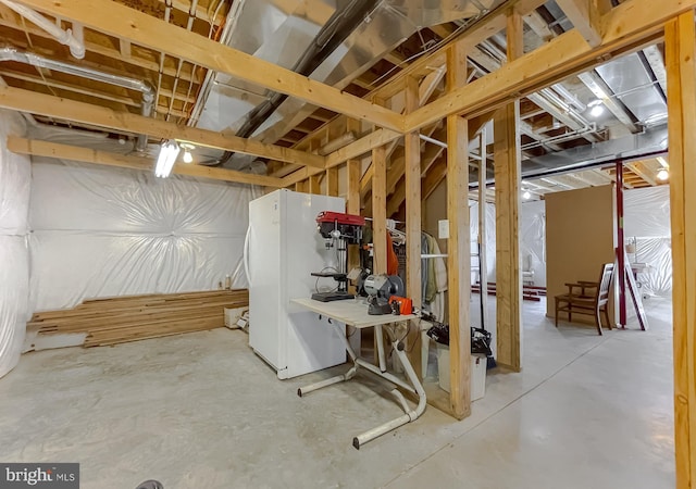 basement featuring white fridge