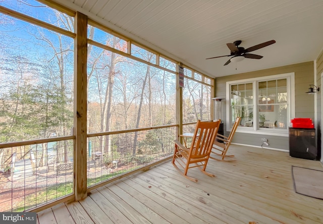 unfurnished sunroom featuring ceiling fan