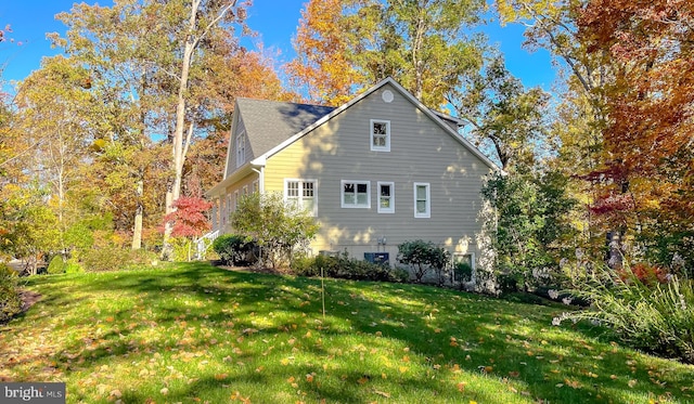 view of side of home featuring a lawn