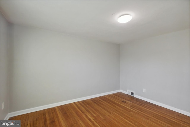 spare room featuring wood-type flooring