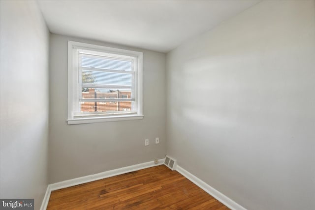 spare room featuring dark hardwood / wood-style floors