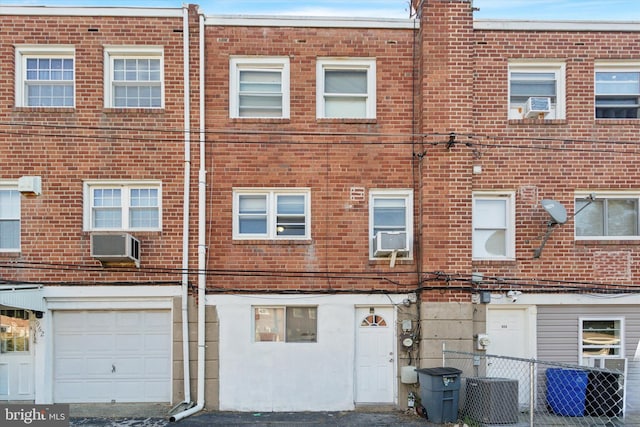 exterior space featuring cooling unit and a garage