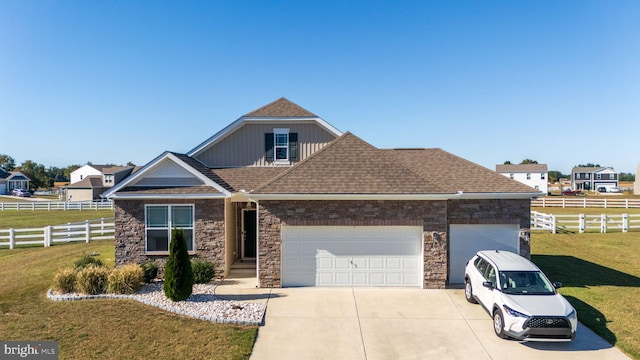 view of front of home featuring a front yard and a garage