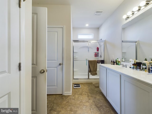 bathroom with vanity and an enclosed shower