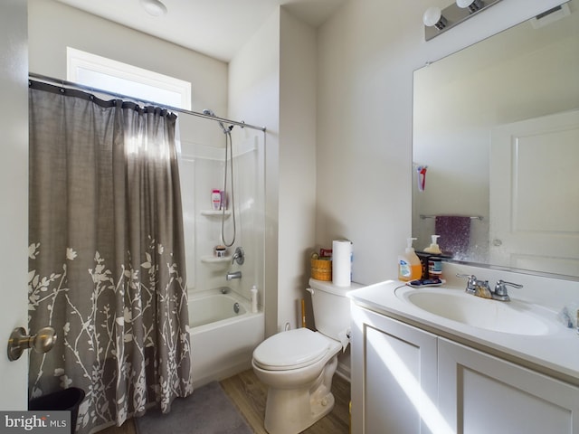 full bathroom with vanity, toilet, shower / bath combo with shower curtain, and hardwood / wood-style floors