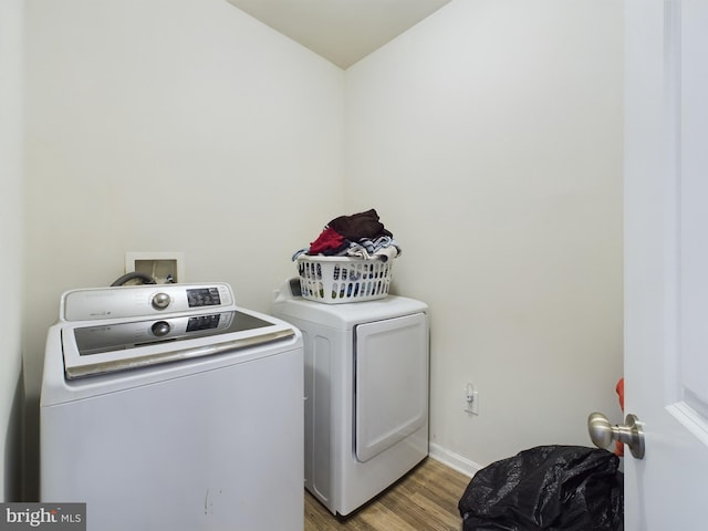 washroom featuring washer and clothes dryer and light wood-type flooring