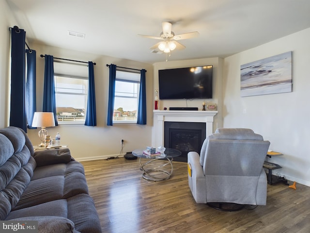 living room featuring ceiling fan and hardwood / wood-style floors