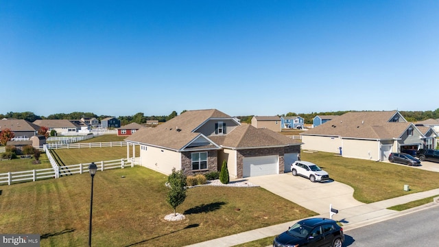 view of front of property featuring a front yard and a garage