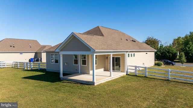 rear view of house featuring a yard and a patio area