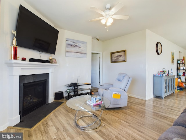 living room featuring ceiling fan and light wood-type flooring