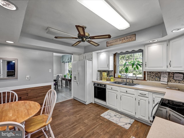 kitchen with dishwasher, white refrigerator with ice dispenser, electric range, white cabinets, and dark wood-type flooring