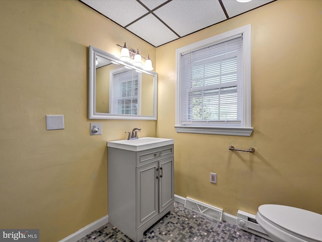 bathroom featuring vanity, a paneled ceiling, toilet, and tile patterned floors