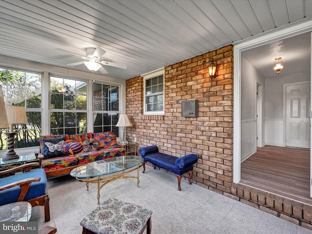 sunroom featuring ceiling fan and wooden ceiling