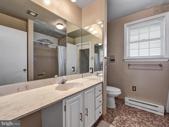 bathroom with vanity, toilet, and a baseboard heating unit