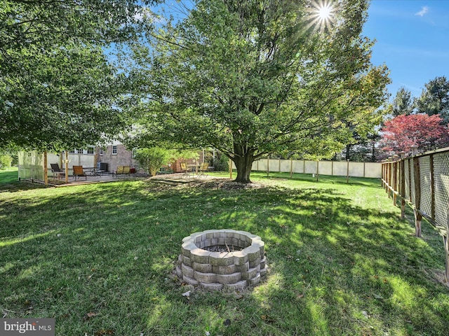 view of yard featuring a patio and a fire pit