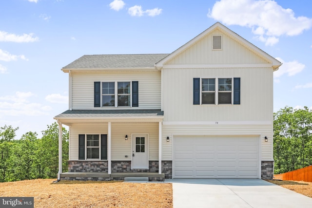 view of front property featuring a porch and a garage