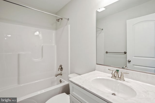 full bathroom featuring bathtub / shower combination, vanity, and toilet