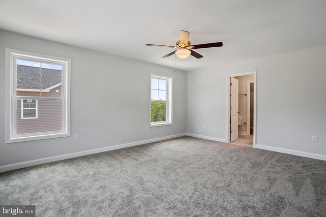 carpeted empty room featuring ceiling fan