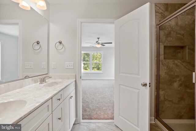 bathroom featuring ceiling fan, walk in shower, and vanity