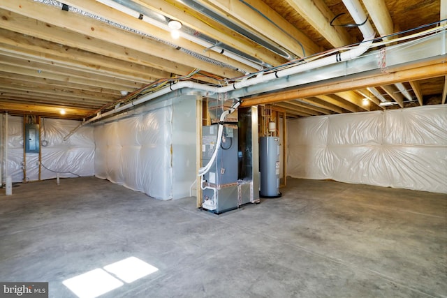 basement with electric panel, heating unit, and water heater