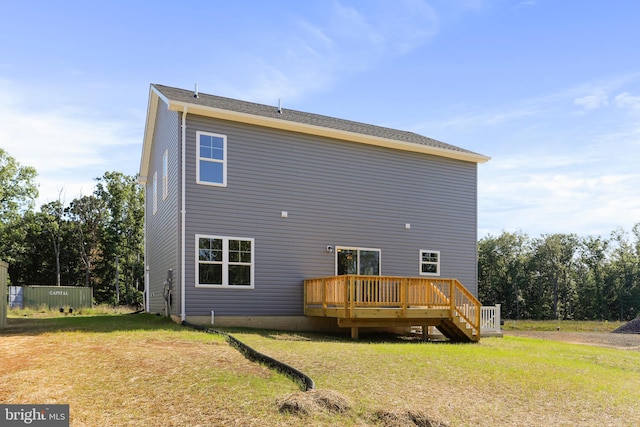 back of house with a deck and a lawn