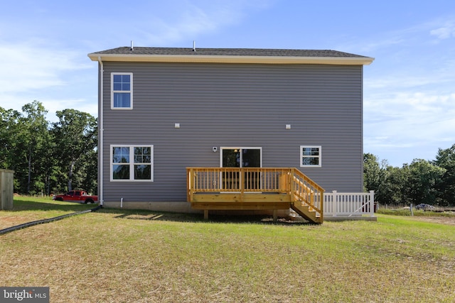 back of property featuring a yard and a wooden deck