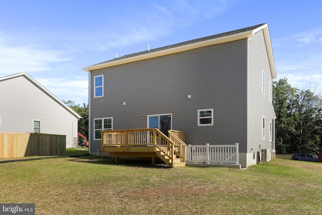 back of property featuring a yard and a wooden deck