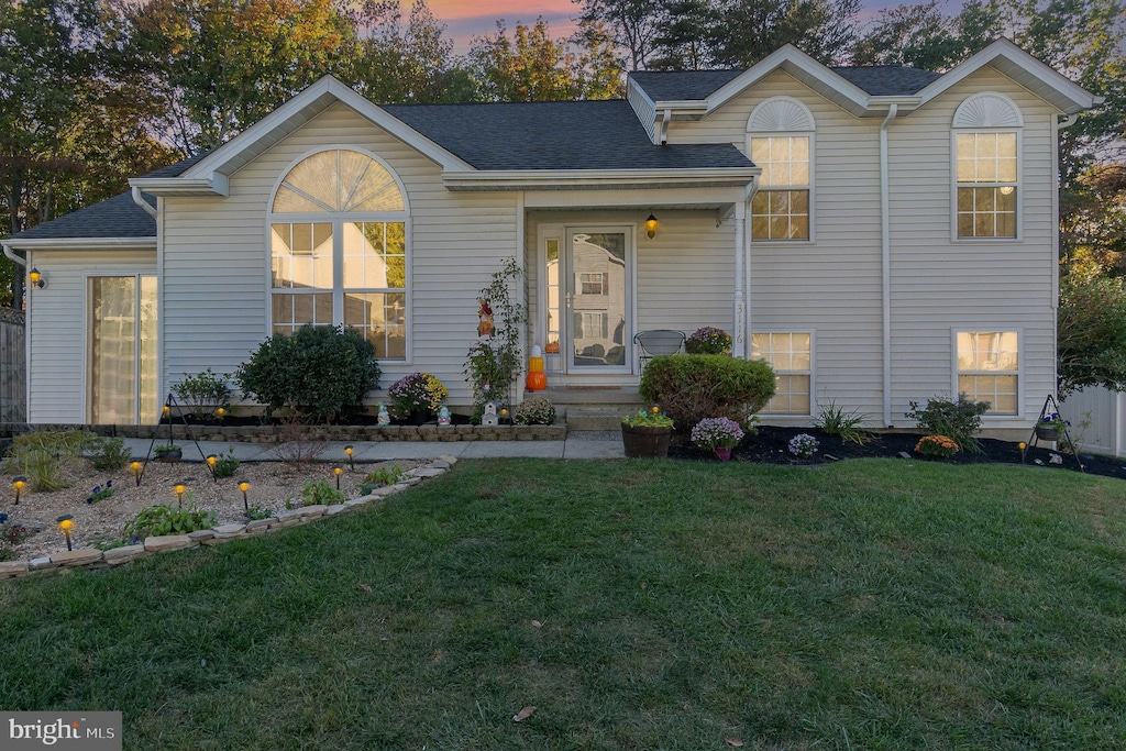 view of front of home with a lawn