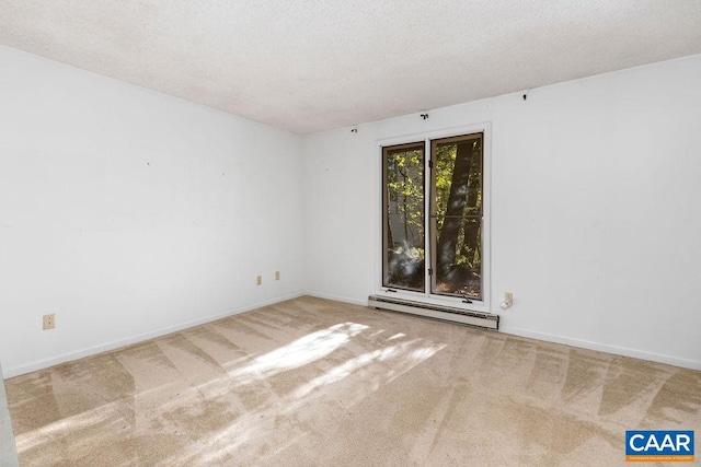 spare room featuring carpet floors, a baseboard radiator, and a textured ceiling