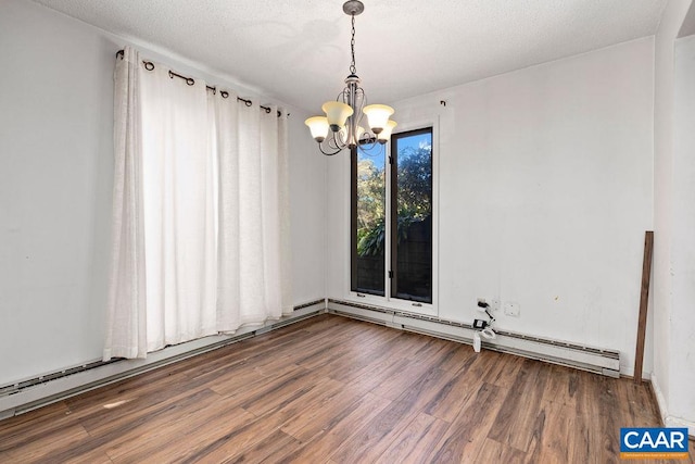 unfurnished room featuring hardwood / wood-style flooring, a notable chandelier, and a textured ceiling