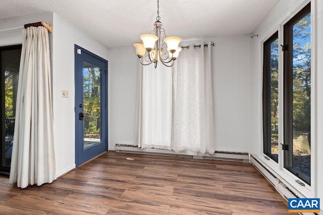 unfurnished dining area with an inviting chandelier, plenty of natural light, and dark hardwood / wood-style flooring