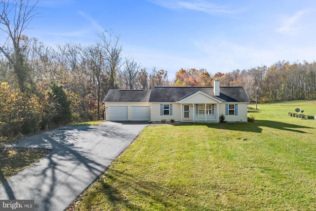 view of front of property with a front yard, a porch, and a garage