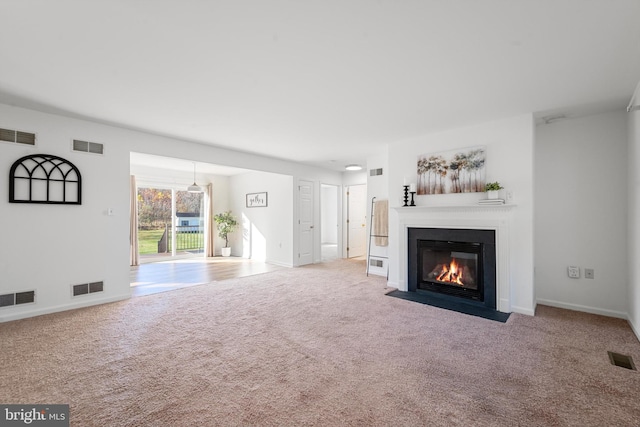 unfurnished living room featuring carpet floors