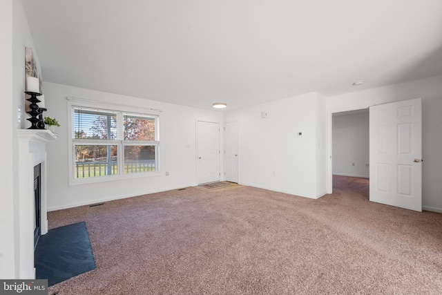 unfurnished living room featuring carpet flooring