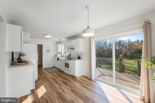 kitchen featuring light hardwood / wood-style flooring, white cabinets, a healthy amount of sunlight, and white appliances