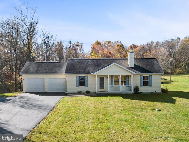 single story home featuring covered porch, a front yard, and a garage