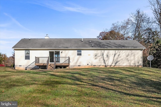 back of property featuring a yard and a wooden deck