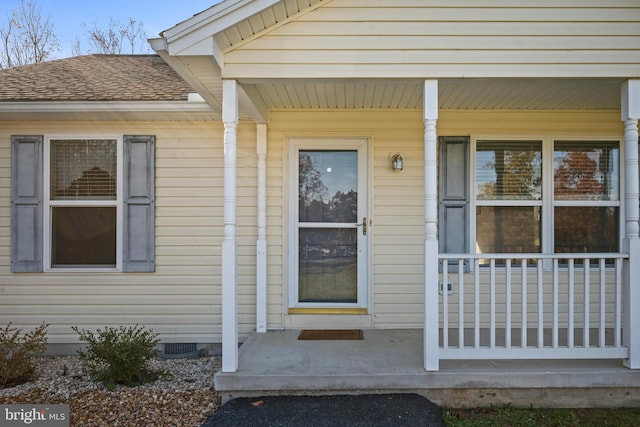 view of exterior entry with covered porch