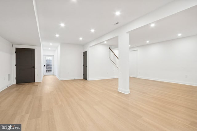 basement with light hardwood / wood-style flooring