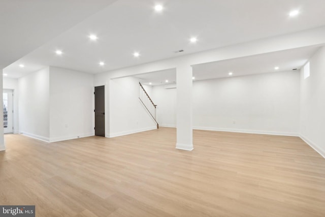 basement with light hardwood / wood-style flooring