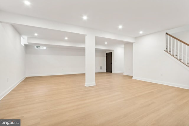 basement with light hardwood / wood-style floors