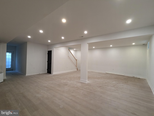 basement featuring light hardwood / wood-style flooring