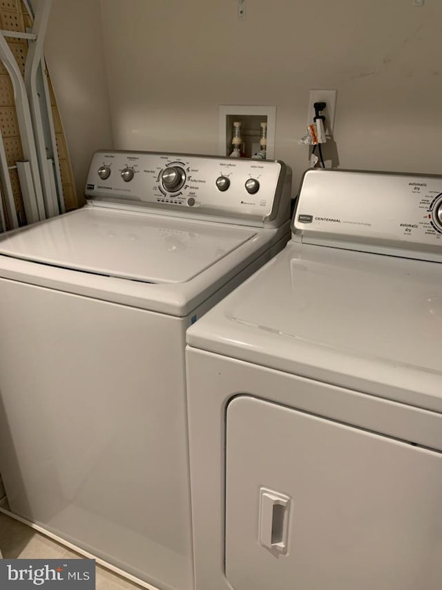 clothes washing area featuring independent washer and dryer