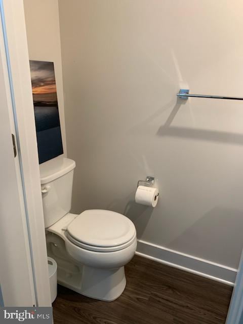 bathroom featuring toilet and wood-type flooring