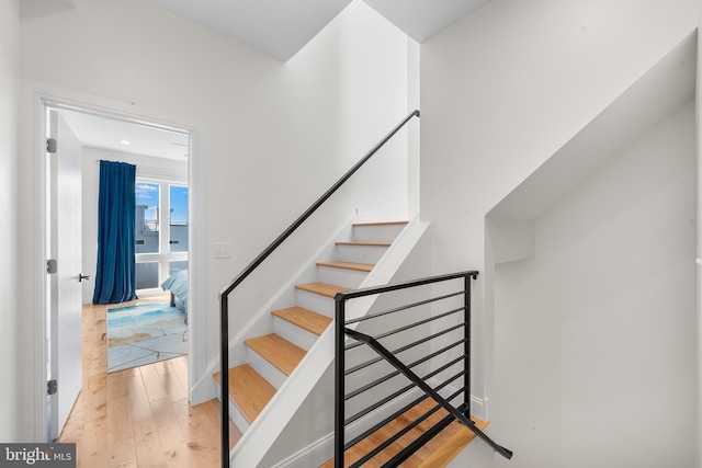 stairs with hardwood / wood-style flooring