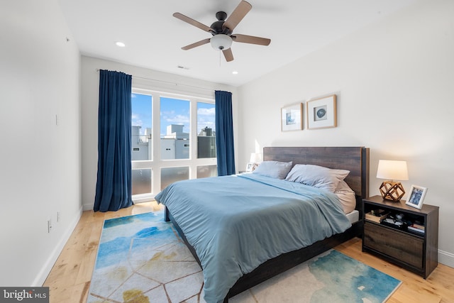 bedroom with ceiling fan and light wood-type flooring